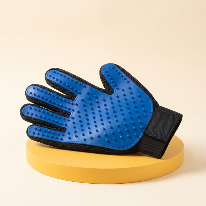 Wagello Purr Glove in blue with soft rubber nubs on a yellow stand